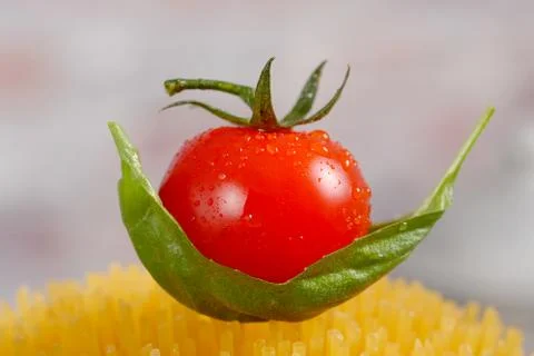 Close-up of a cherry tomato on pasta Stock Photos