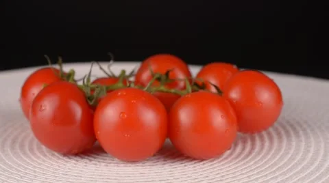 Close up of cherry tomatoes on black background Stock Footage 65227849
