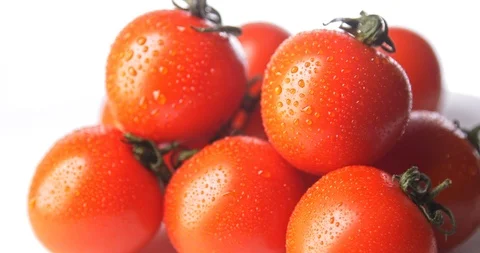 Close up cherry tomatoes with drops of water rotating on white background Stock Footage 122178273