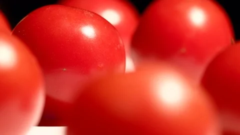 Close up of cherry tomatoes rotating over dark background Stock Footage 119770959