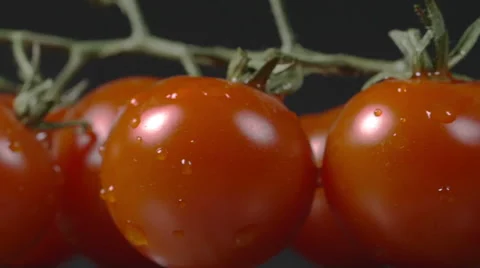 Close-up of cherry tomatoes rotating on a plate Stock Footage 60192049
