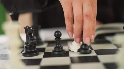 Close up of chess pawns and pieces on checkered board with hands moving during Stock-Footage 346649985