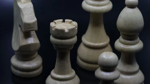 Close-up chess pieces on black background with light Stock Footage 171555475