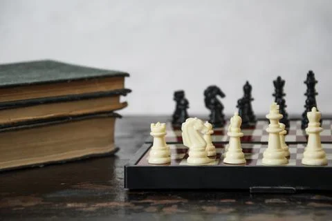 Close-up of chess pieces placed on chessboard at beginning of the game and st Stock Photos