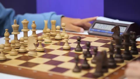 Close-up of chess players' hands moving pieces on wooden board Stock Footage 345379512