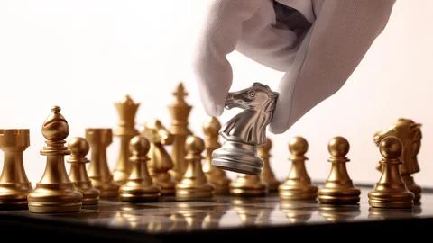 Close up chesses strategy concept of silver and gold chess on classic board. Stock Photos
