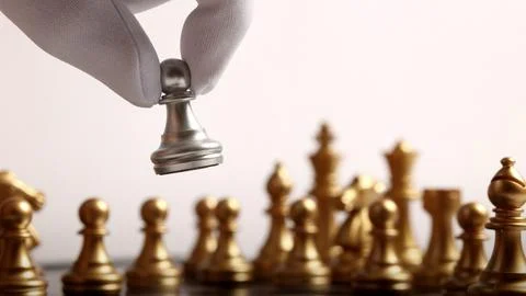 Close up chesses strategy concept of silver and gold chess on classic board. Stock Photos