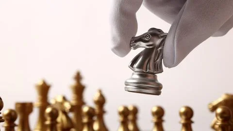 Close up chesses strategy concept of silver and gold chess on classic board. Stock Photos