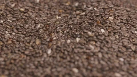 Close-Up of Chia Seeds Into Container and Stirred with Spoon Video stock 292098348