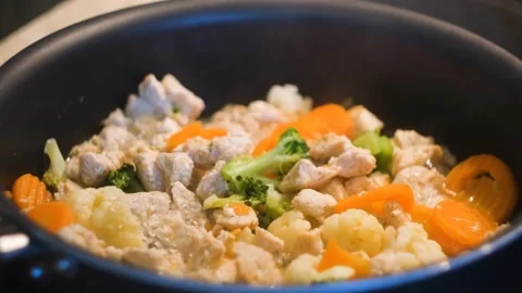 Close-Up of Chicken and Steamed Vegetables Cooking in Pan Stock Footage 314303152