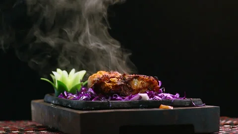 Close-Up Chicken BBQ on Round Table with Smoke Black Background Stock Footage 200953427