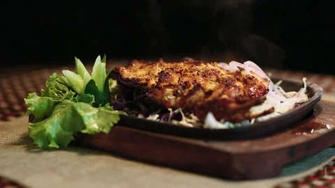 Close-Up Chicken BBQ on Round Table Black Background Stock Footage 200953679