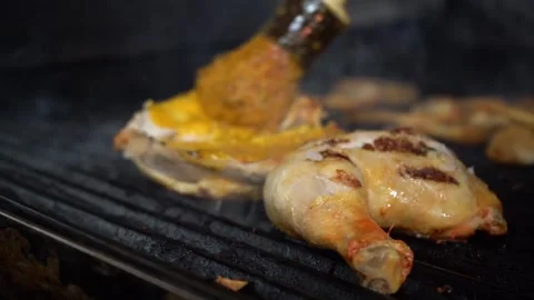 Close up of chicken being marinated on grill Stock Footage 142881643