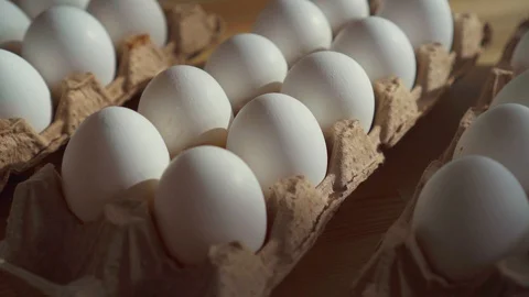 Close up of chicken eggs in a cardboard box on the table. Video stock 106436792
