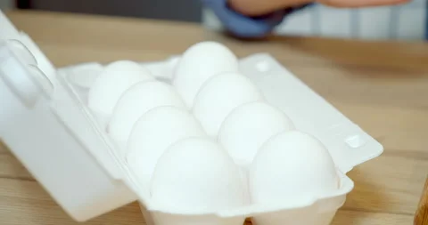 Close-up of chicken eggs in the package. Children's hands taking an egg. Stock Footage 132321018