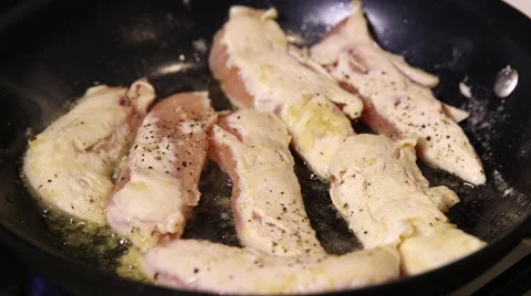 Close up of chicken on frying pan Stock Footage 61350299