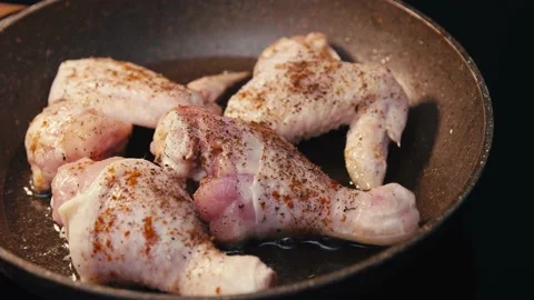 Close-up of chicken legs and wings fried in a pan. Stock Footage 152223948