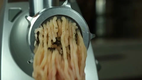 Close-up of chicken meat being grinded on an electric grinder. Stock Footage 152872709