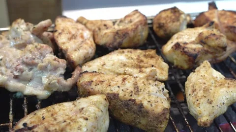 Close-up of chicken meat cooking on a gas grill. Delicious meat. Stock Footage 297845401