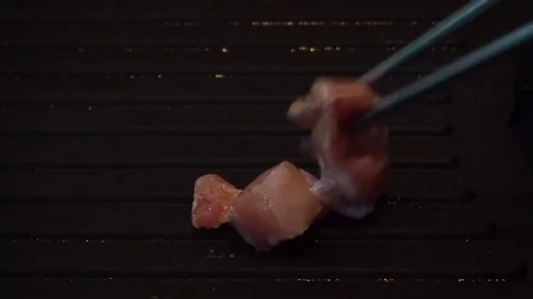 Close up of chicken meat grilling and being charred on non stick frying pan Stock Footage 77604978