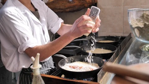 Close-up. Chief grating a cheese, cooking classical Jewish Yemenite food. Cosy Stock Footage 126300102