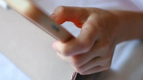 Close up of child actively playing on tablet in bed at home, tapping screen Stock Footage 337663773