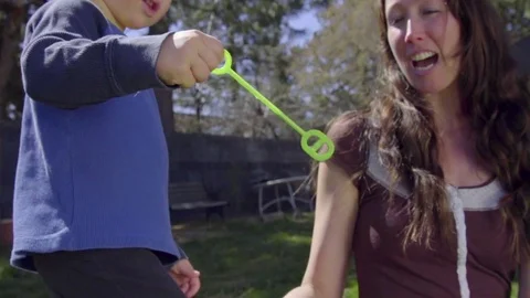 Close up on child blowing a play bubble Stock Footage 74117541