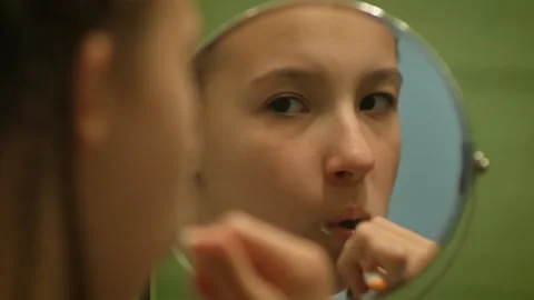Close up of a child brushing his teeth reflection in the mirror Video stock 130877128
