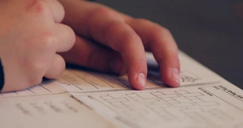 Close up of child doing homework and studying at the kitchen table Stock Footage 72759739