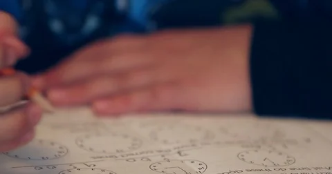 Close up of child doing homework and studying at the table 動画素材 72759761