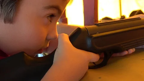 Close up Child draws a bead and shoots with rifle Stock Footage 116173556