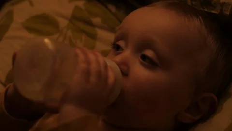 Close up of child drinking bottle of milk before bed. Stock Footage 102561279