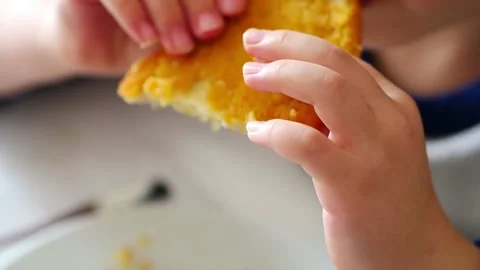 Close-up of a child eating fried Chicken Schnitzel, Stock Footage 166322789