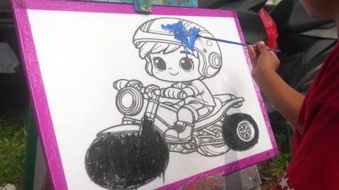Close up of a child hand coloring a cartoon Stock Footage 321979512
