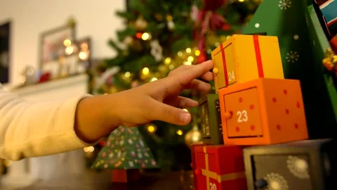 Close up of child hand opening advent calendar 動画素材 140398329
