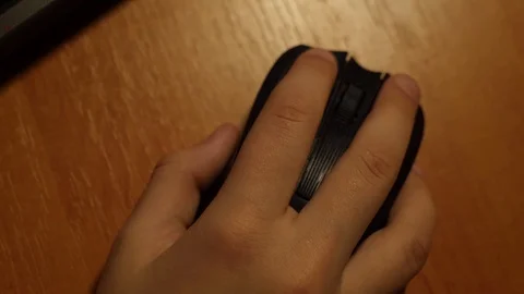 Close-up of child hand using mouse computer on wood table. Stock Footage 89040179