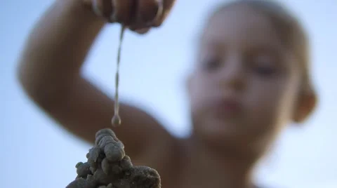 Close up of child hands making sand castle on blue sky background. Slow motion Stock Footage 50148507