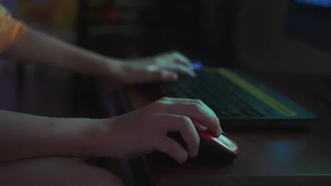 Close-up of child hands playing computer video game with the mouse and keyboard Stock Footage 279819469