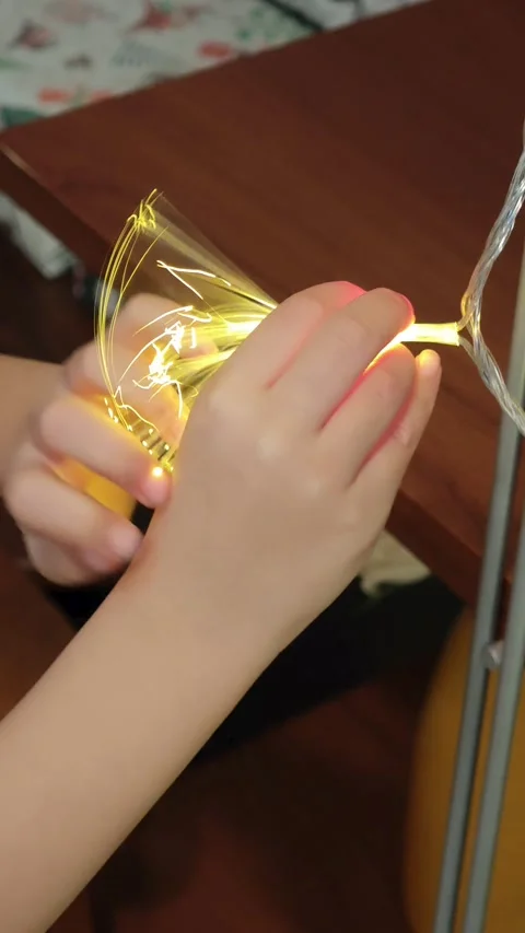 Close up of child hands playing with glowing LED fiber optic lights Video stock 332893049