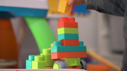 Close Up Child Hands Taking Colorful Blocks From Box and Stacking Them Video stock 330971533