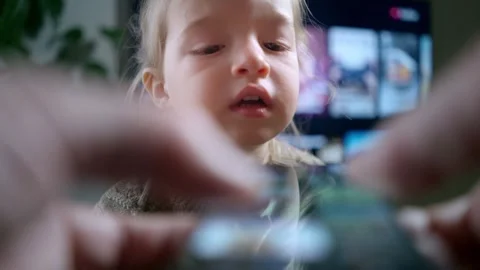 A close-up of child interacting with a smartphone screen. Stock Footage 300088919