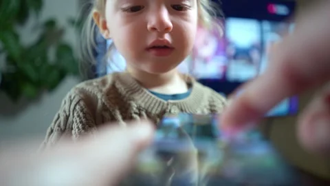 A close-up of child interacting with a smartphone screen. Stock Footage 300089180