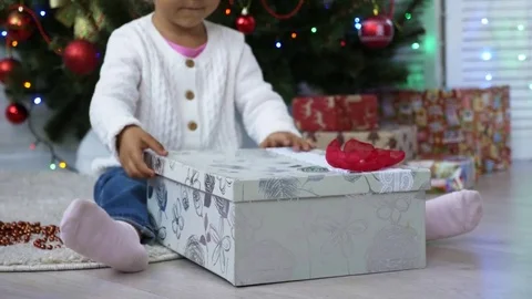 Close up of child opening a Christmas present Stock Footage 77082997