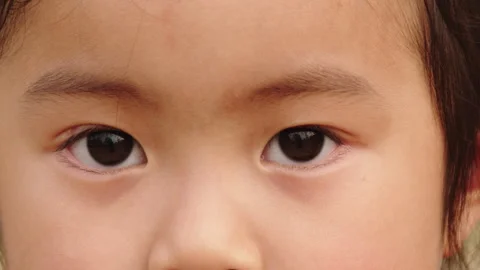 Close-up of Child Opening Eyes with Curious Expression 库存影片 334829614