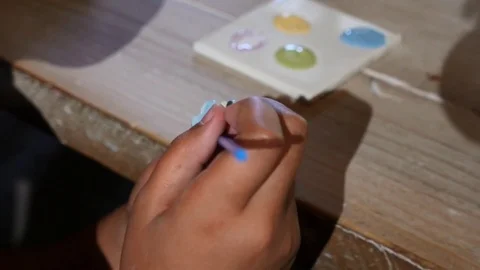 Close up of a child painting a craft project Stock Footage 74902181