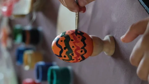 Close-up of child painting Easter egg at table 스톡 동영상 265603207