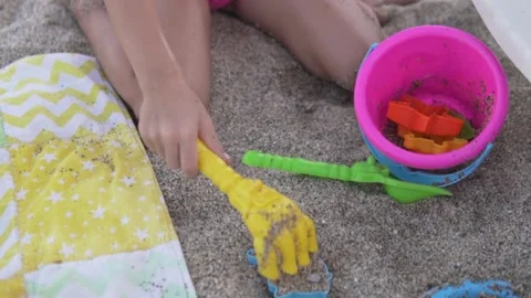 Close-up, a child playing in the sand on the beach in the summer Video stock 218116355