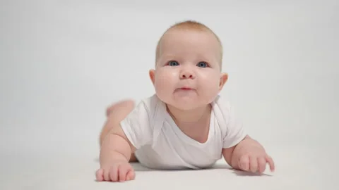 Close-up of a child with a positive emotion on a white background Stock Footage 233164875