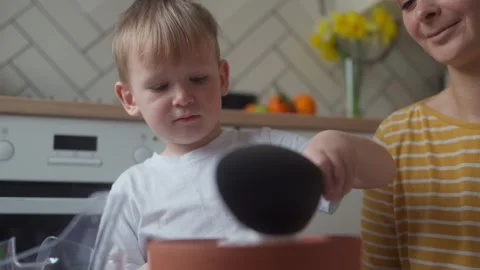 Close-up of child pouring perlite into a pot of soil for planting seedlings Stock Footage 331437923