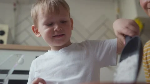 Close-up of child pouring perlite into pot of soil for planting seedlings Stock Footage 331438189
